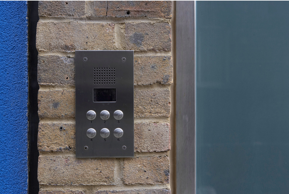 Image of an IP intercom system that is flush mounted outside a Washington DC building, this one had six button for six apartments.